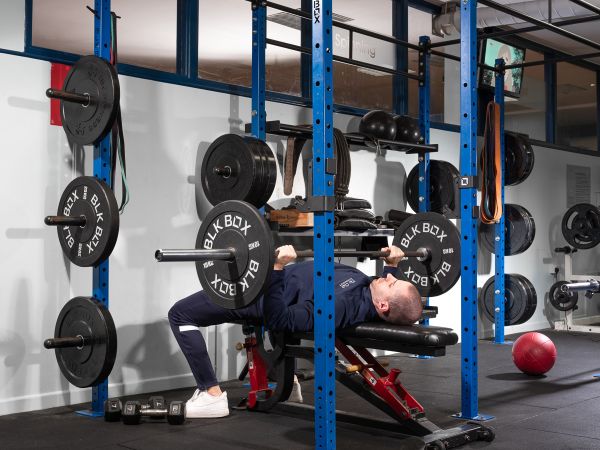 Gym instructor lifting weights